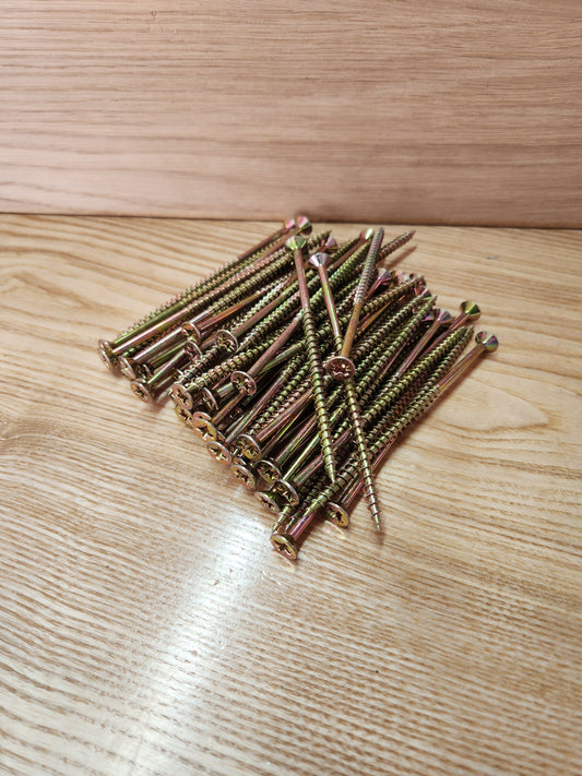 Stack of screws on a wooden surface