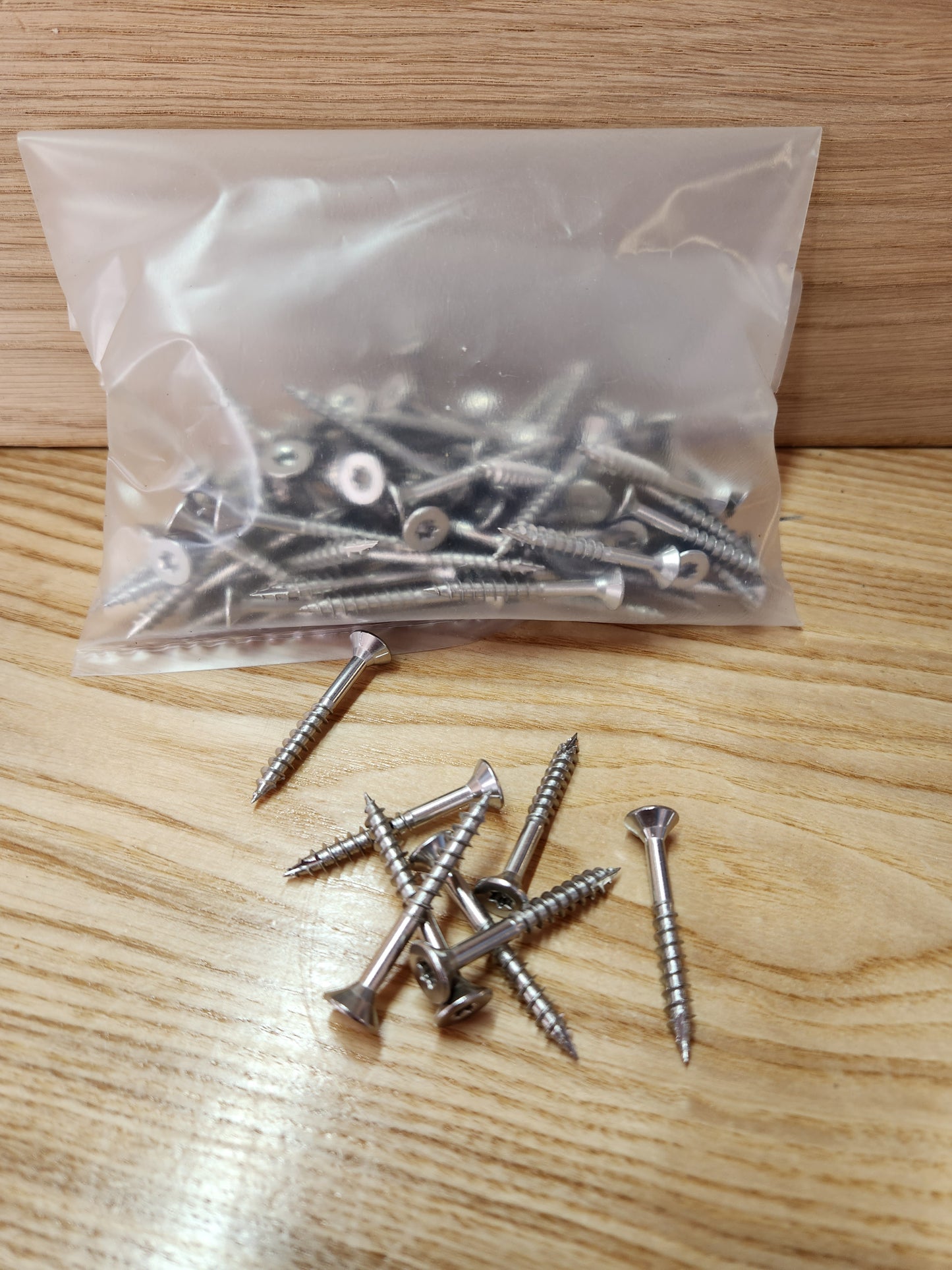 Bag of screws on a wooden surface